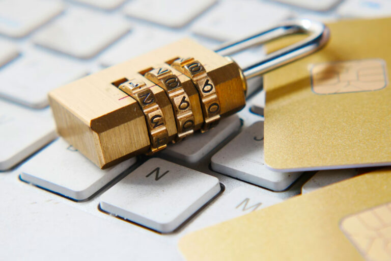 Primer plano de un candado cerrado colocado sobre las teclas de un ordenador portátil, ilustrando el concepto de protección de datos y ciberseguridad en el entorno corporativo.